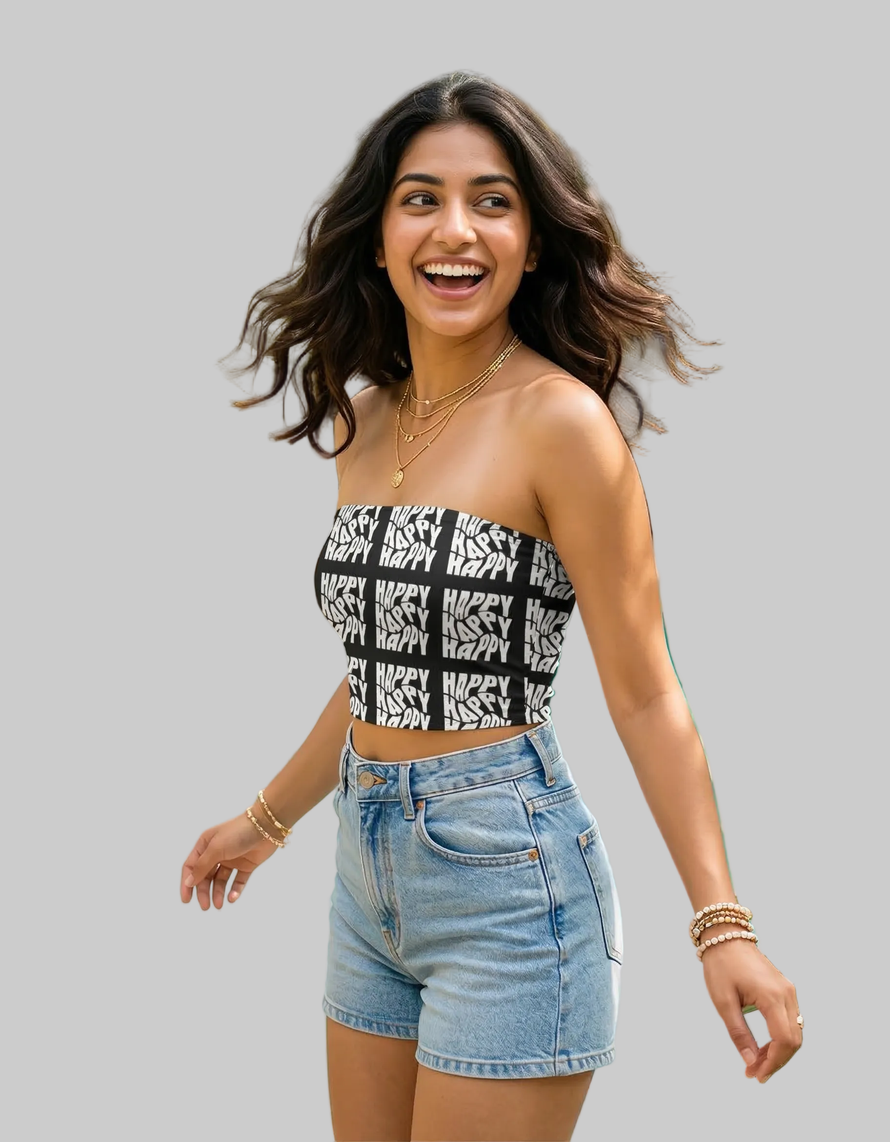 Woman in a patterned top and denim shorts.