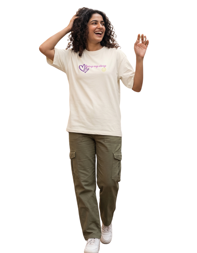 Woman wearing a off white t-shirt with text and graphics, standing on a white background