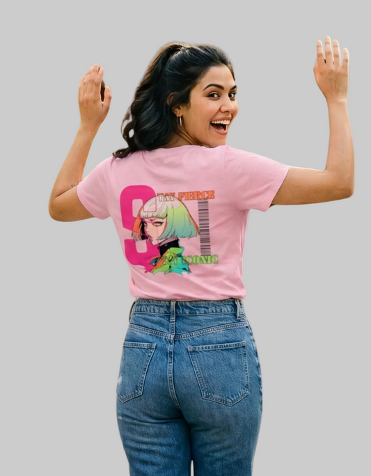 Woman wearing a pink t-shirt with a anime graphic design on the back, standing against a white background.